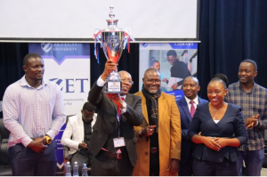 KCB RFC Head Coach Andrew Amonde(left), KEFWA Chairman James Situma (Seated), Zetech University VC Prof. Njenga Munene (with trophy), Gaspo FC Coach Jacob ‘Ghost’ Mulee and GRIA Insurance Director Nathaniel Mukoma (third from right) during the varsity’s Sports Awards Luncheon.