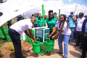 L-R Deputy Governor Machakos County,H.E Hon Francis Mwangangi and Public Health and Proffesional Standards ,PS Mary Muthoni (R) getting their hands washed by Joan Kimani during the Global handwashing d