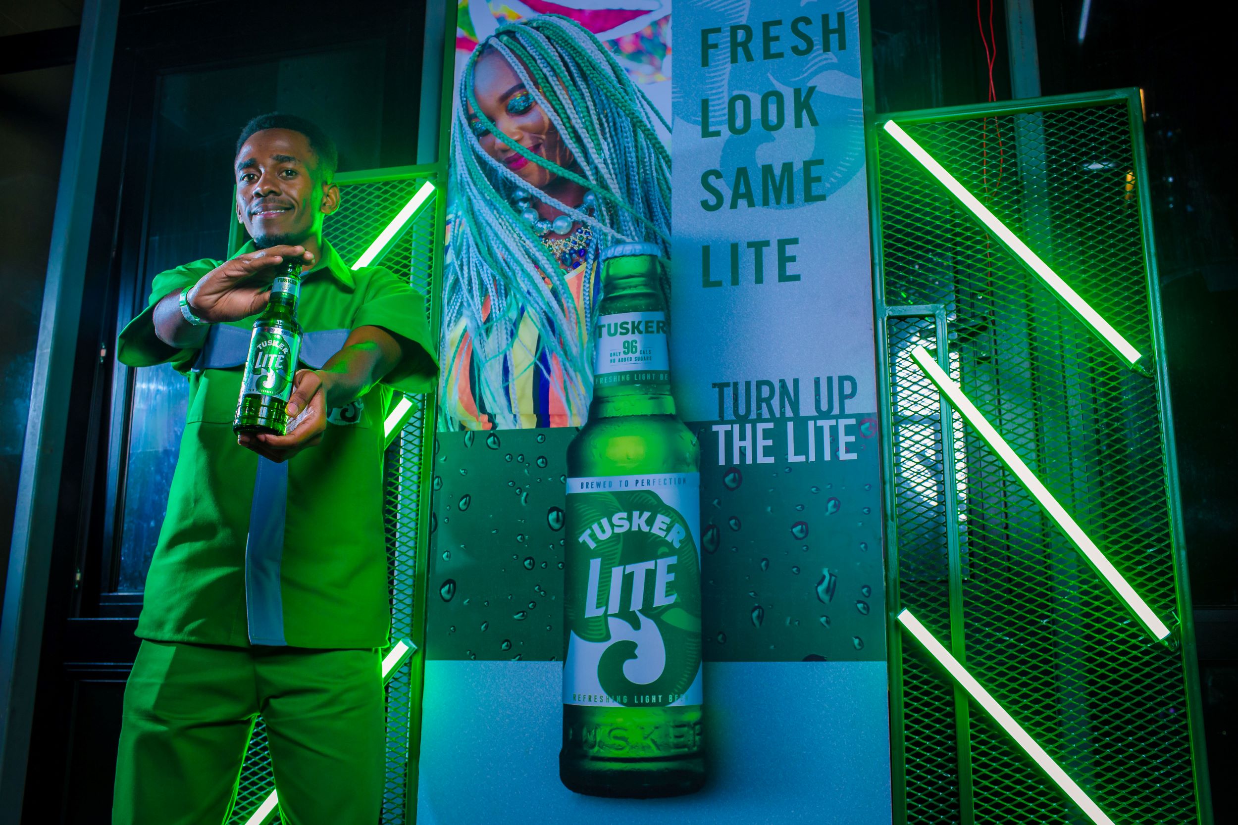 Jason Mwangi posing with the new Tusker Lite pack at Koda Nairobi